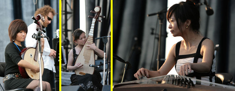 From left to right: Wang Yi Ping on the Zhong Ruan (circular oversized wooden banjo type of instrument,) Dong Nan on the Pi Pa (the pear shaped instrument,) and Qiu Ji playing the GuZheng (horizontal instrument, somewhat like a zither.)