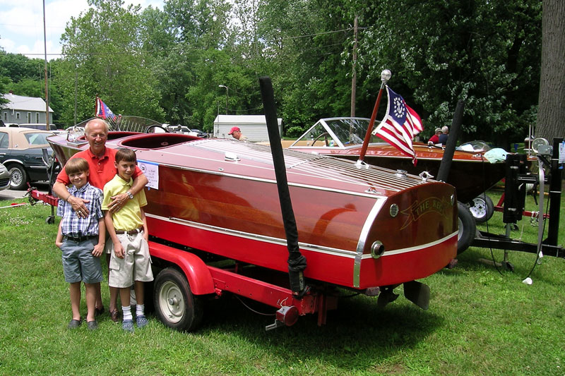 Mike Boone and grandsons Parker and Brock with his 1938 Chris Craft.