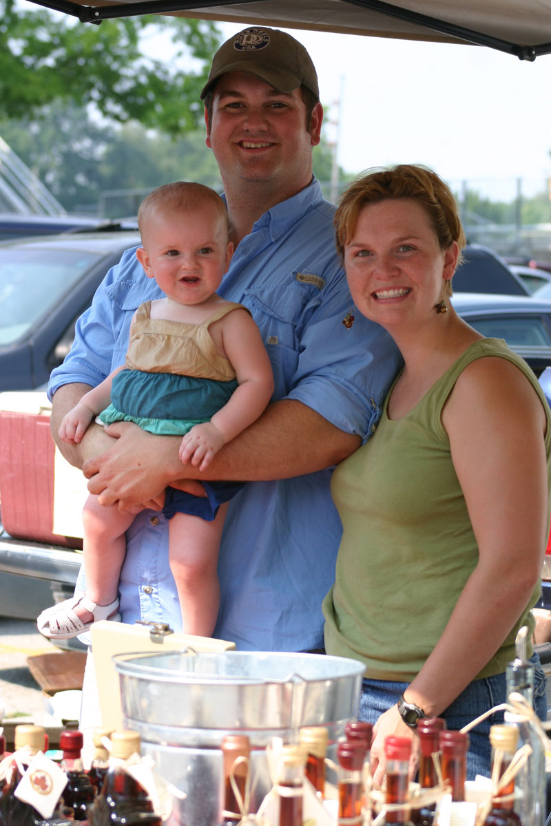 Burton's Maplewood Farm's Sabrina and Greg Burton at the July 19 market with the next generation of maple makers Brynn.