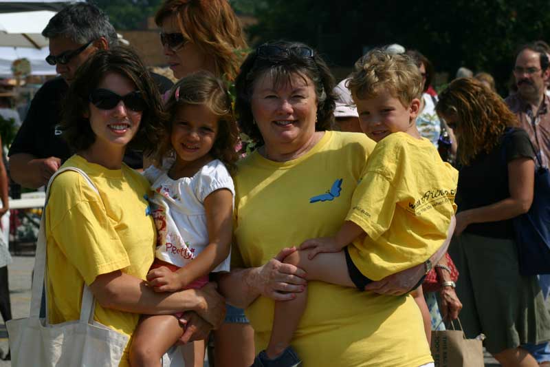 Fran (right), Aimee (left) and grandchildren at the Broad Ripple Farmers' Market in their yellow What Friends Do Shirts.