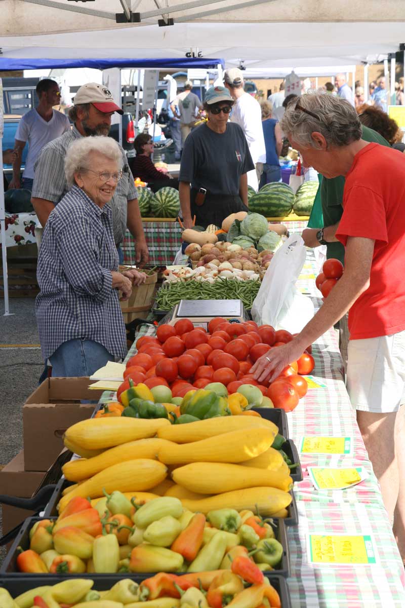 Coral, who grew up in Broad Ripple, with a customer at the Azalia Market booth