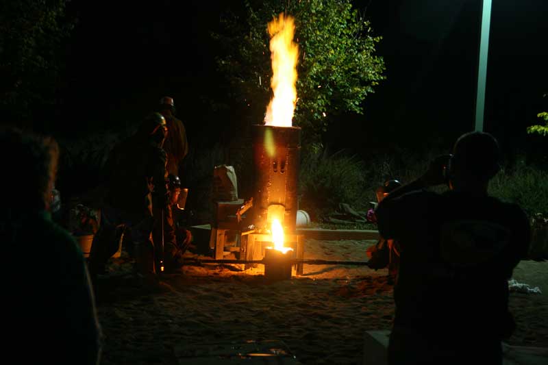 One of six furnaces at the Art Center releasing its iron into a crucible.