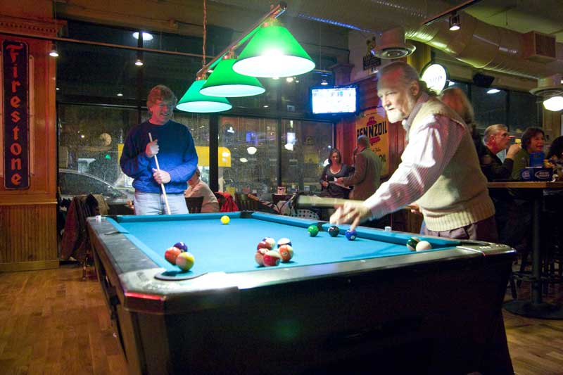 Peter Dean and Michael Freeland try out the new pool tables