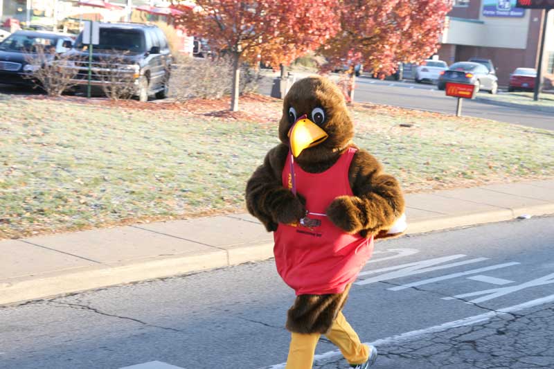 Six-foot turkey in his annual trek down Broad Ripple Avenue with thousands chasing after him.