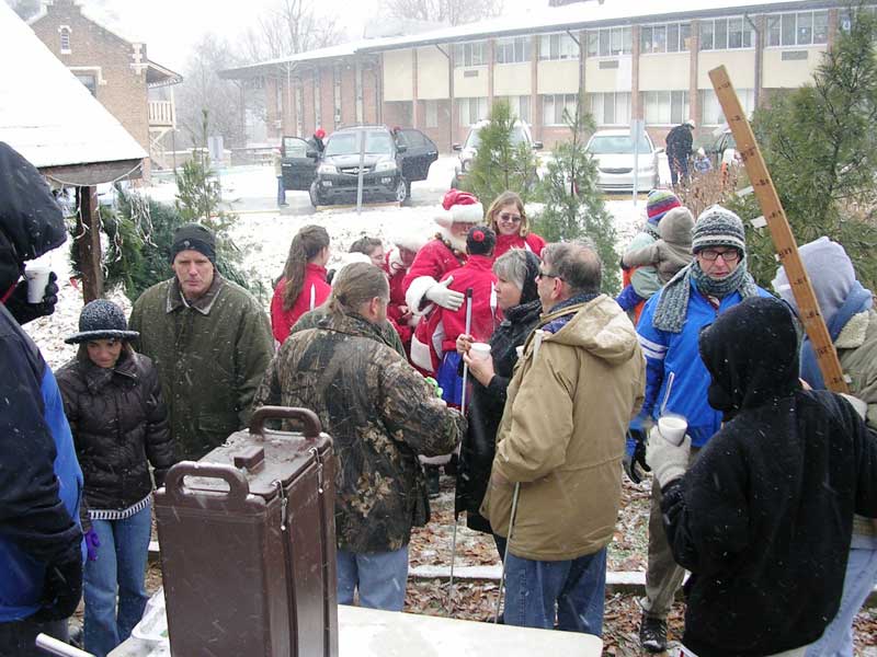 Santa & Mrs. Claus greet people at ISBVI Christmas tree sale