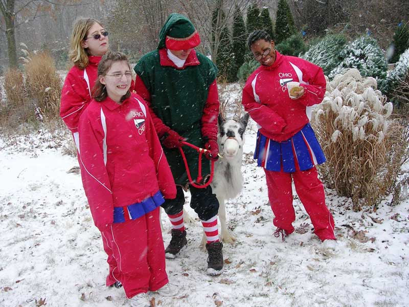 Visiting Ohio cheerleaders appear with Santa's reindeer