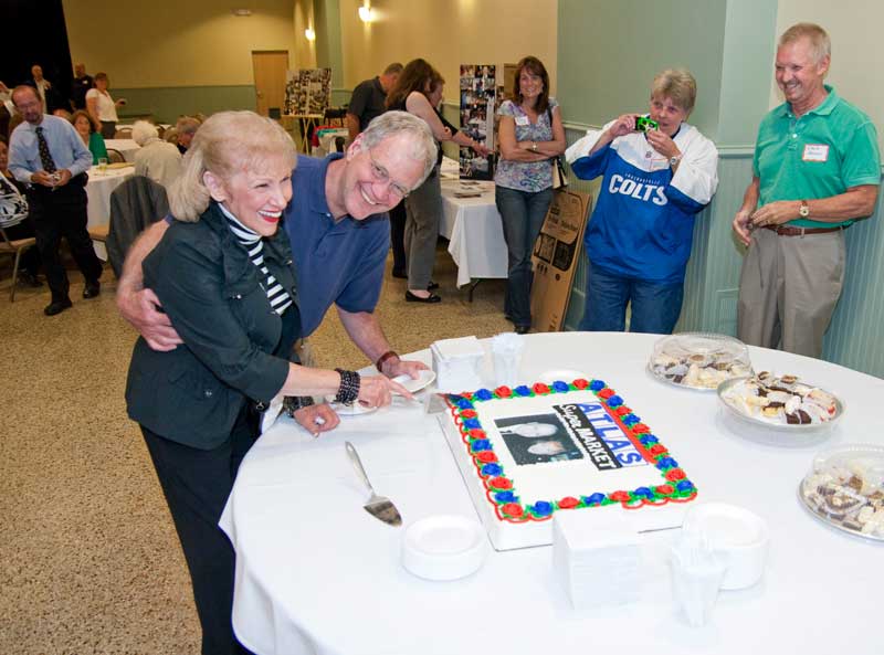 Eleanor Maurer and David Letterman cut the first piece of cake at the Atlas reunion.