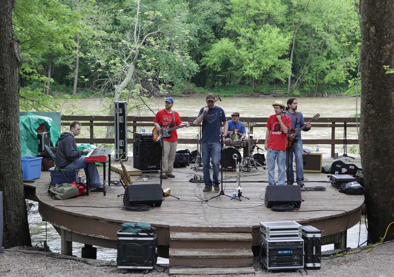 The musical group Unlikely Alibi performed at the Riverfront Stage despite the surging waters beneath the stage. They performed a sequence of refreshing reggae songs.