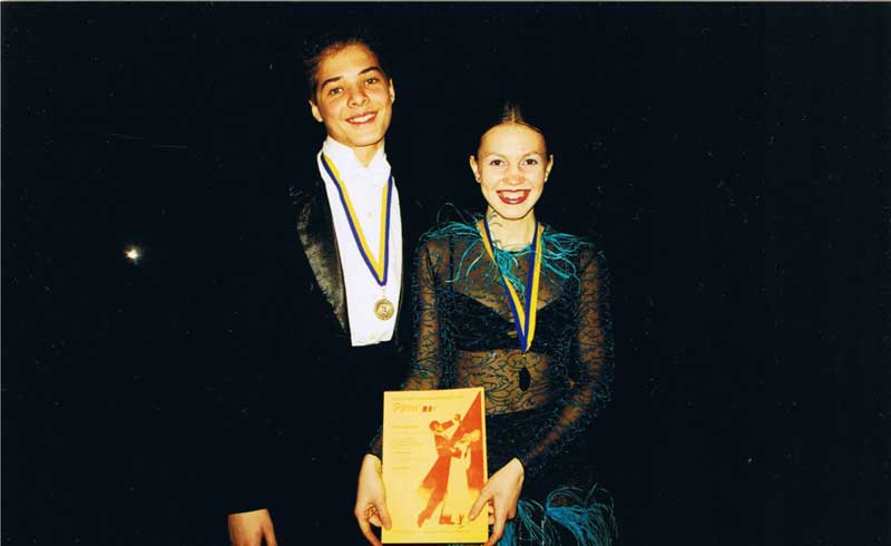Michael and his dance partner display their awards won for placing third in Zaporozhye's Open Dance Championship.