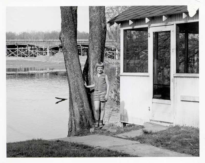 Janie Maines on the bank of the White River with the bridge under construction in the background.