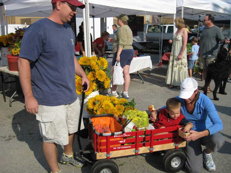 Scott Reed pulling his son Tyler. Tyler's mom Julie helps with the fresh raspberries.