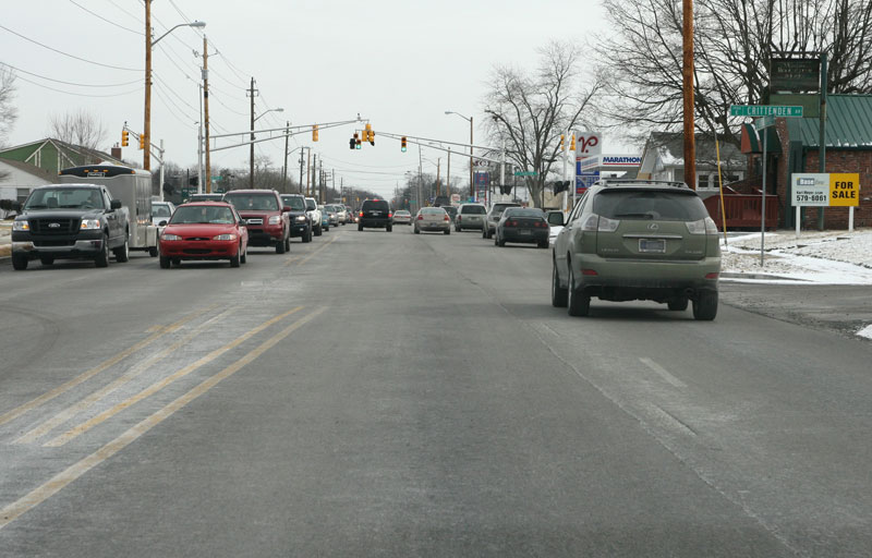 Looking east on Broad Ripple Avenue toward Evanston. The new intersection layout has moved lanes to the right, but without proper lane markings the pavement seam (visible in the photo starting in the lower right corner) confuses drivers.