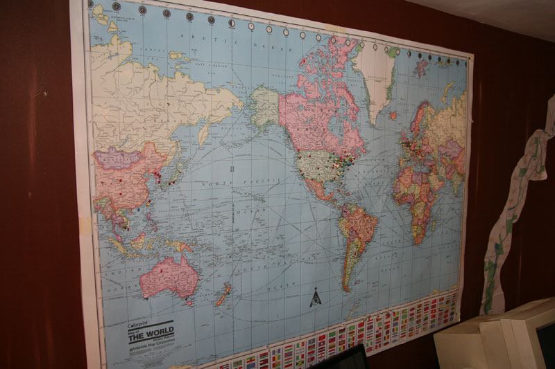 Pins in the map wall of the library show that guests come from around the world.