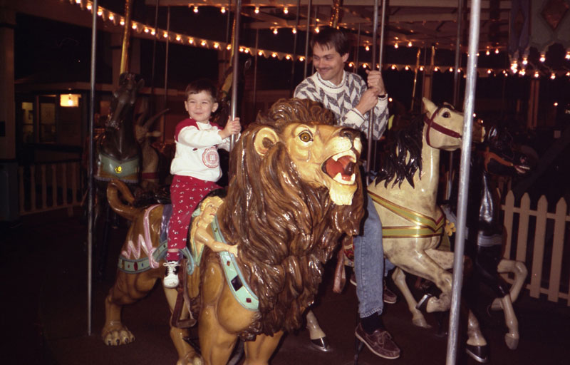 The Gazette's crossword clue writer and recipe columnist on the carousel at the Children's museum in 1990 - John S. Hague and Douglas Carpenter.