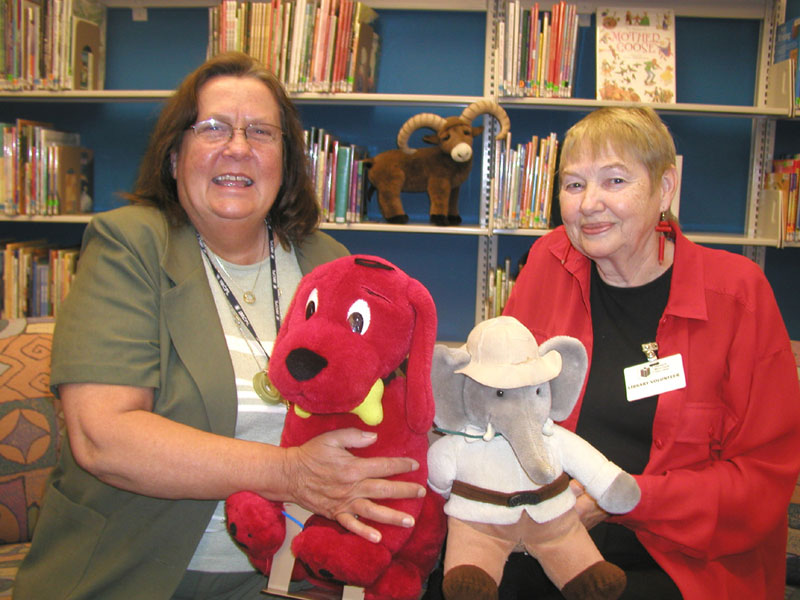 Glendale Branch patron and volunteer Barbara Smith (right) is joined by Branch Manager Joyce Karns in the library's children's area following Smith's donation in support of Glendale's Summer Reading Program.