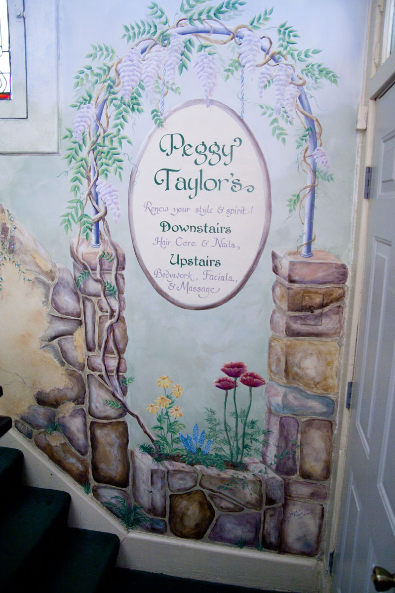 A mural that runs from the main floor to the second floor of the salon.