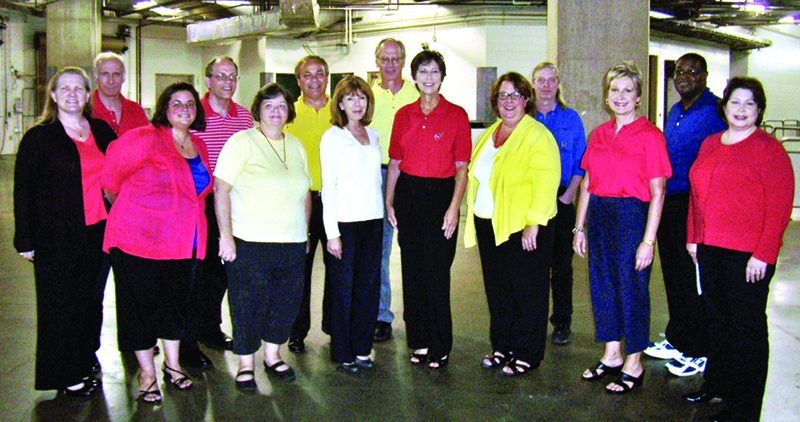 The alumni chorus backstage at the Conseco Field House (back row, l to r) Judd Cromer (1971), Richard Tensmeyer (1977), John Hiatt (1974), John Kaellner (1965), Richard Keefe (1975), and David Summers (1974); (front row l to r) Marie Atkins Taylor (1978), Gretchen Schaller (1994), Cheryl Duckworth Decker (1970), Kim Lasalle Hiatt, Jamie Heidenreich Poynter (1969), Kelly Kennedy Bentley (1977), Leslie Olsen (1975), and Nancy Balzerick Chastain (1977).