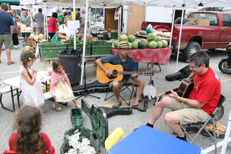 Mario Joven and Ted Kirkendall played guitars and mandolins at the market