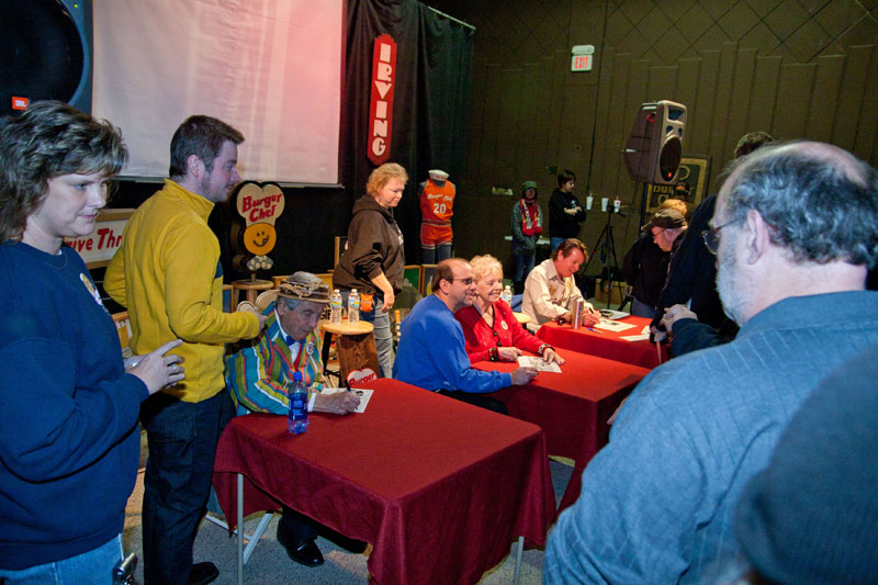 Hal Fryar (Harlow), Janie Hodge, and Bob Glaze signing autographs and posing with fans.