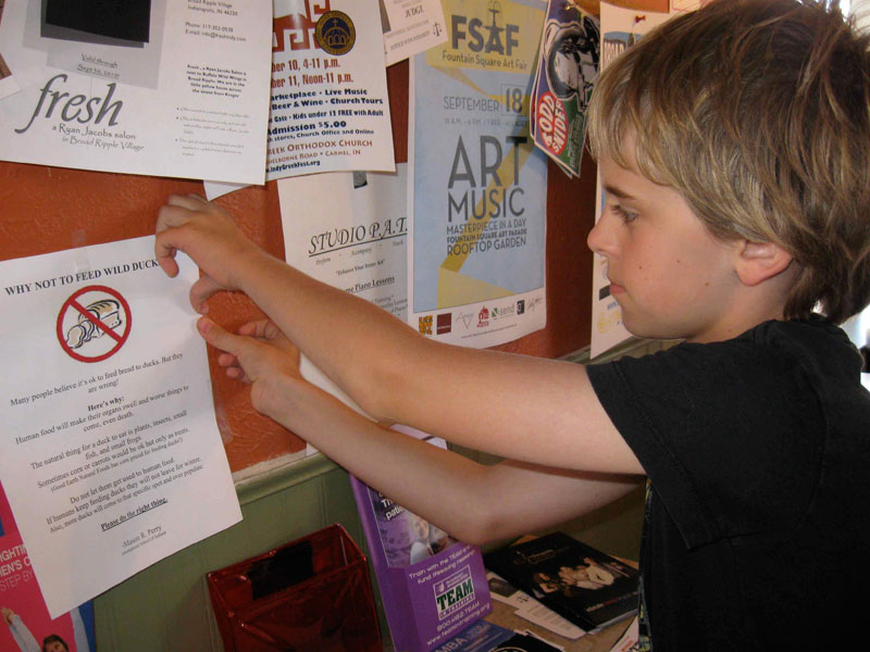 Mason pins up a flyer at Dagwood's