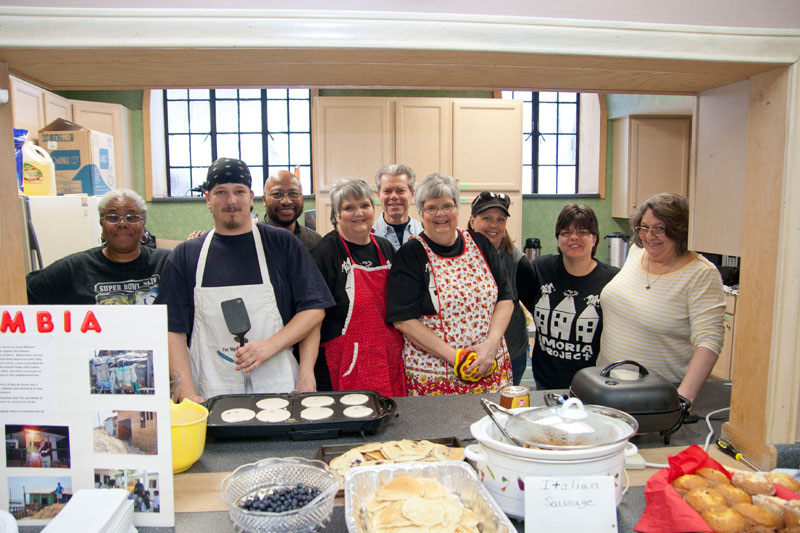 Carole Miller, Bradley Bell, Jerry Officer, Jean Kolvgord, Dwight Hall, Joan Wristen, Amy Busenberg, Carla Kincade, and Debbie Busenberg in the kitchen at New Paradigm Church.