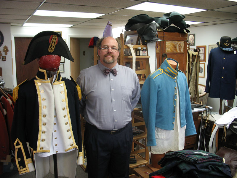 Smoking Iron Alterations proprietor Michael Dollinger with an 1812 era British captain coat and a light blue 1830s American Artillery coat worn during the 2nd Seminole war.