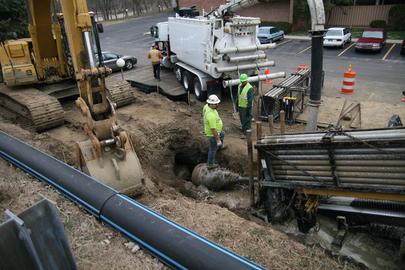 The drill and the end of the new water pipe attached has broken through on the south side of the river.