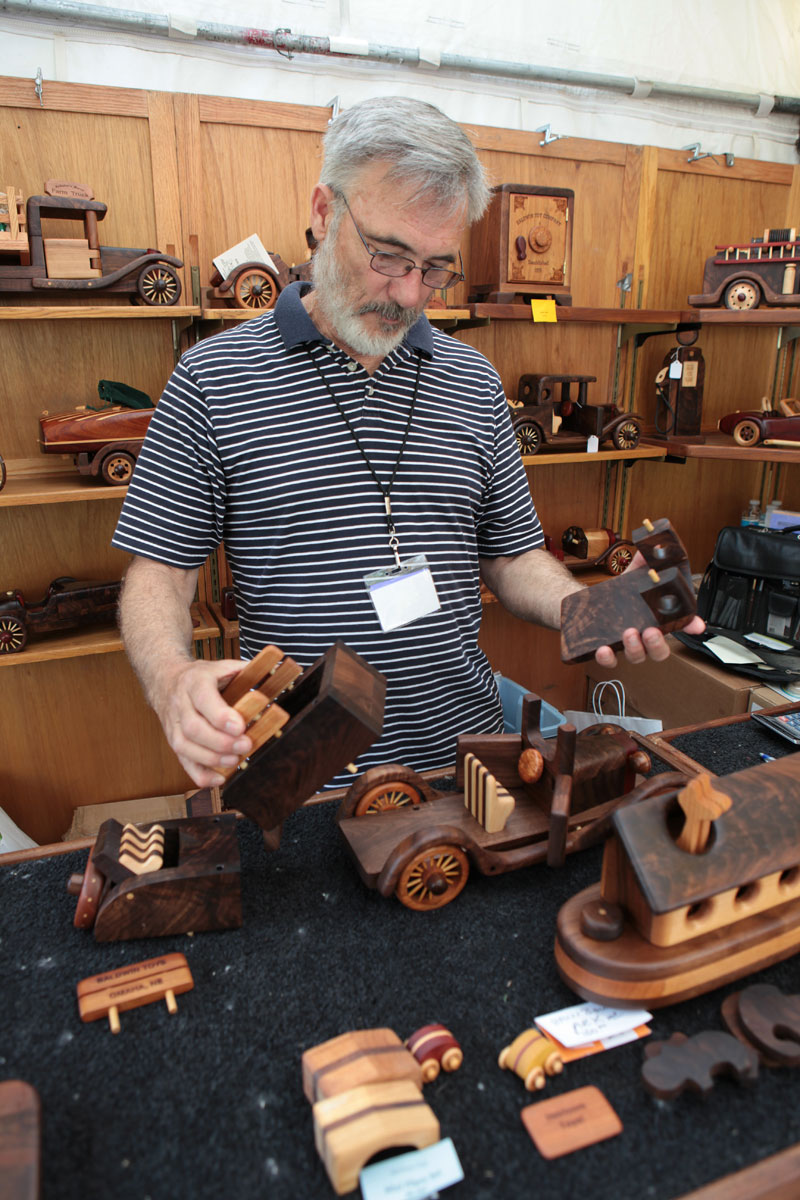 Steve Baldwin demonstrates a wood car available at his Baldwin Toys booth at the 2011 Broad Ripple Art Fair. These intricate pieces are a wonderful mixture of art, craftsmanship, toy, and puzzle. We wanted to stay and play all day!