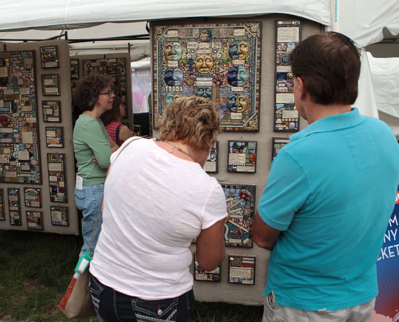 Ceramic inspirational art by Mindy and Greg Rhodes kept visitors studying their pieces for longer periods. These 3 dimensional pieces incorporate tiles with short poems, sayings, or simply a word or two. Bits of second-hand recycled items add to the mosaics.