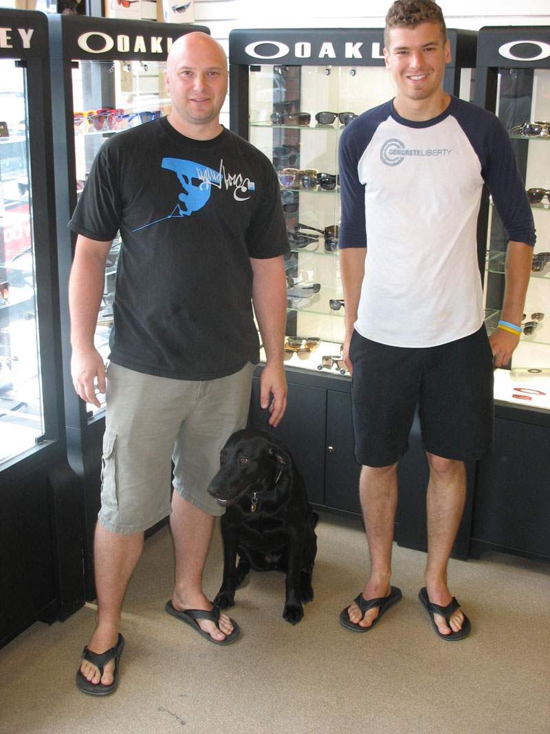 Brad Maley, Raley (a Labrador Retriever) and Garrett Wilson at the Ripple Surf and Board Shop.