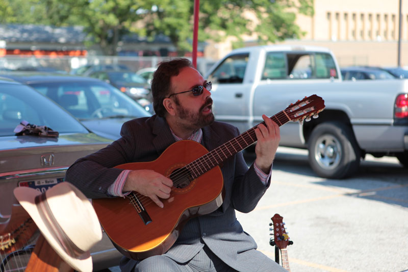 Robert Bruce Scott performed traditional songs on guitar and harp at the Broad Ripple Farmers Market.