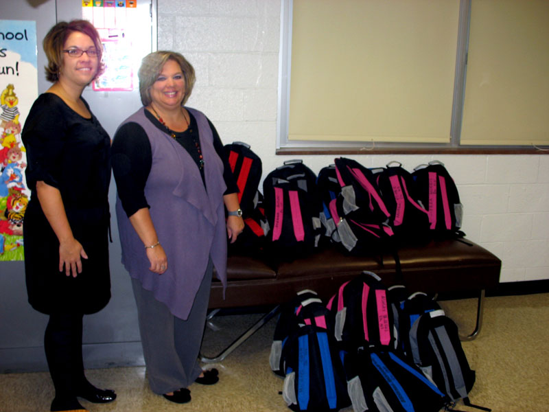 IMA CFO Jennifer Bartenbach helps organize Blessings in a Backpack at IPS #55.