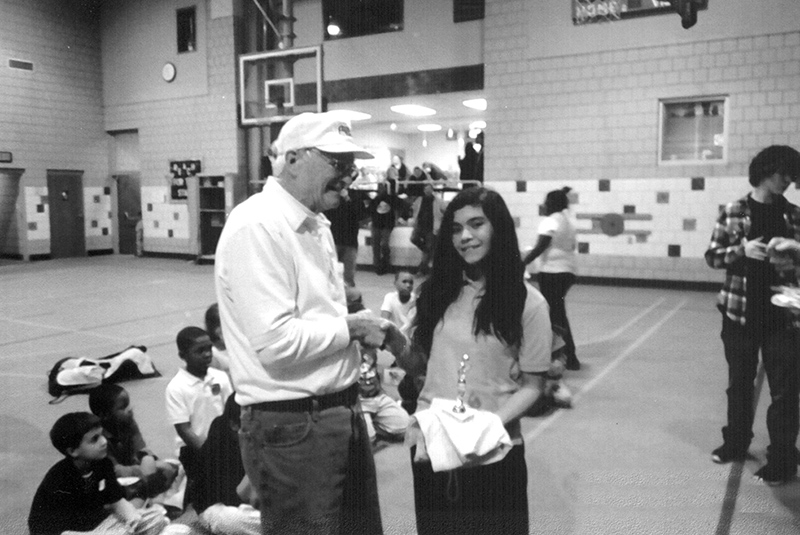 Elmer Bradshaw presents and award at the Concord Center Basketball Contest.