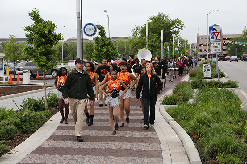 Assistant Band Director John S. Hague leads the Broad Ripple band along the trail