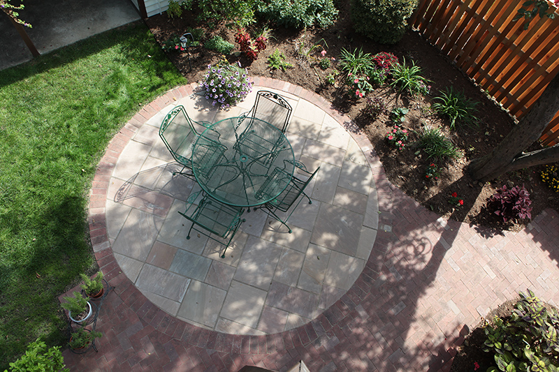 This is a downward view of patio and garden from the second story deck at 6125 Haverford Avenue.