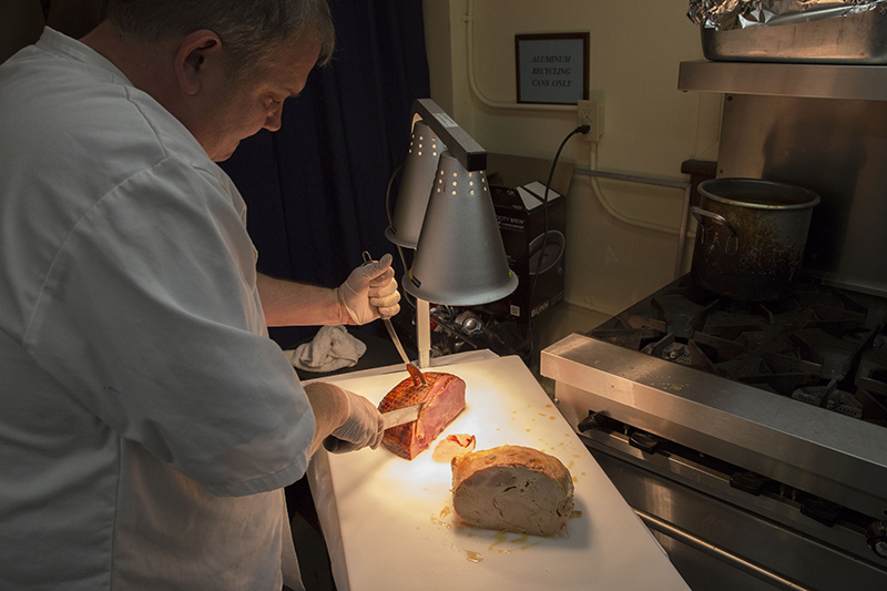 Owner of Steer In carves the ham