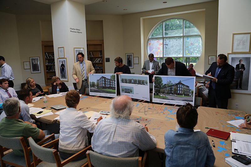 Item E on agenda - Michael Kosene, left, describing the proposed 63-unit apartment building on 66th Street next to Opti Park.