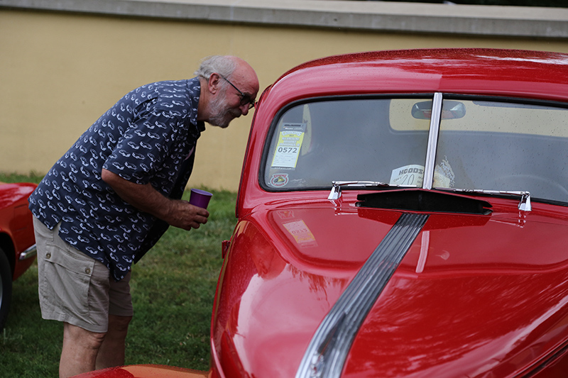 Hood & Hops organizer John Hill inspects a 1939 Pontiac De Luxe 2-door sedan. It original price: $871!