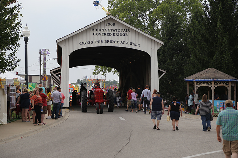 The daily tractor parade passing through the covered bridge
