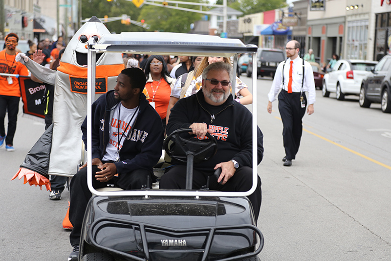 Principal Mike Akers (driving) leads the 2014 parade down Broad Ripple Avenue.