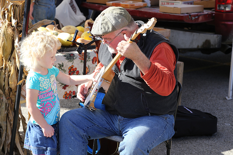 Jon Hall gives an impromptu banjo lesson