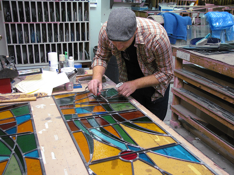 Brooke Camden works on a stained glass window. 