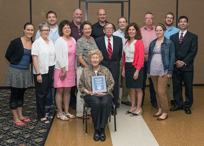 Sandy Fenstermaker with her award and her family members at the ceremony.