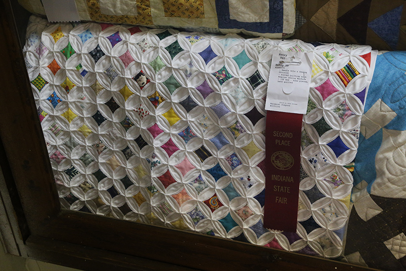After retiring from Indianapolis Public Schools, Gazette reader Peg Simpson won a 2nd place ribbon for her hand-pieced, hand-quilted king sized quilt she has been working for the past 3 years. The pattern is called Cathedral Window. It is a compilation of the many fabrics she has used over the years. 