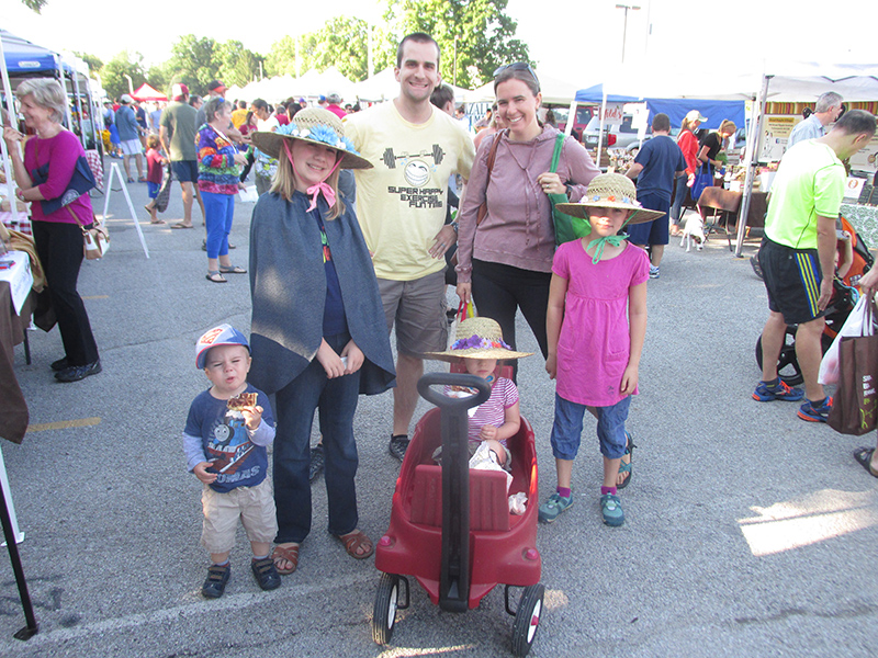 The Froyd girls beat the bright sunshine in their beautiful ornate summer hats. (L to R) are Caleb 2, Becca 10, Nathan (Dad), Maggie 4 (in wagon), Tricia (Mom), and Ally 8