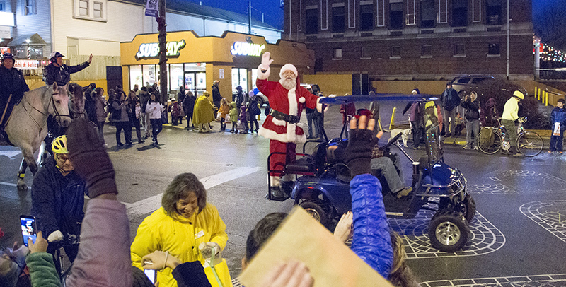 Santa (and the IMPD on horseback) greet all of the parade-goers on Broad Ripple Avenue