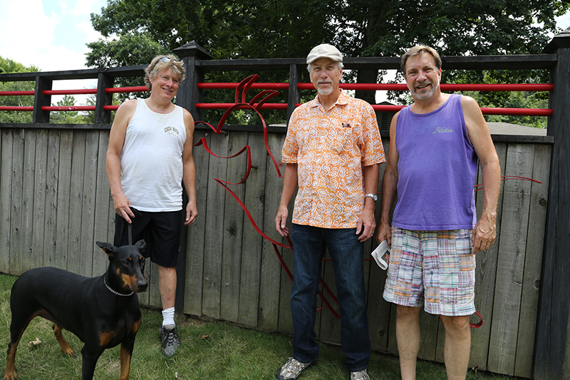 Homeowner Chris Kirby, Gary Noble (sandblasting), and Jim Barnes (artist) with the restored Astro