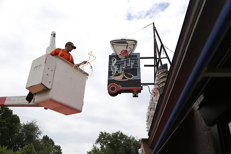 adding the final neon elements to the new sign