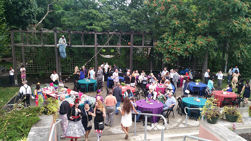 Costumed attendees sat at Alice-themed tables while the Caterpillar (upper right) and the Cheshire Cat (center) looked on