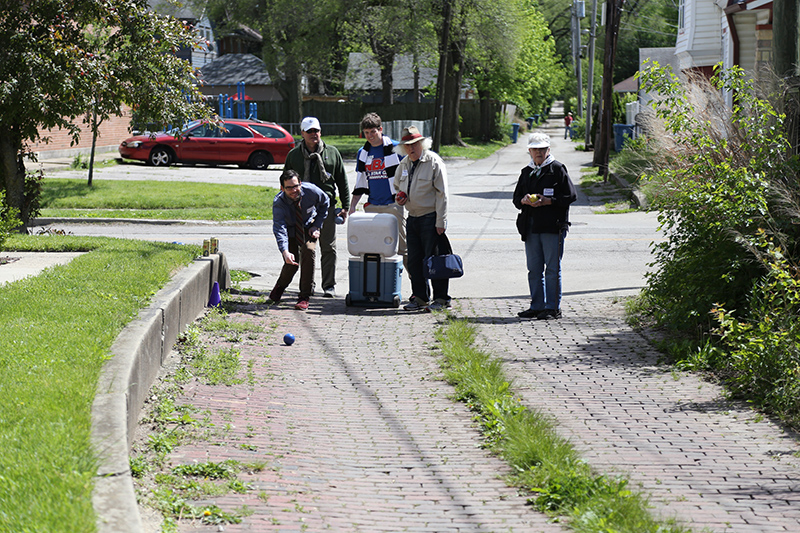 The start of play at 42nd Street. Matt throwing while Bill, Colin, Chuck and Toni watch the ball maneuver the rutted, brick alley.